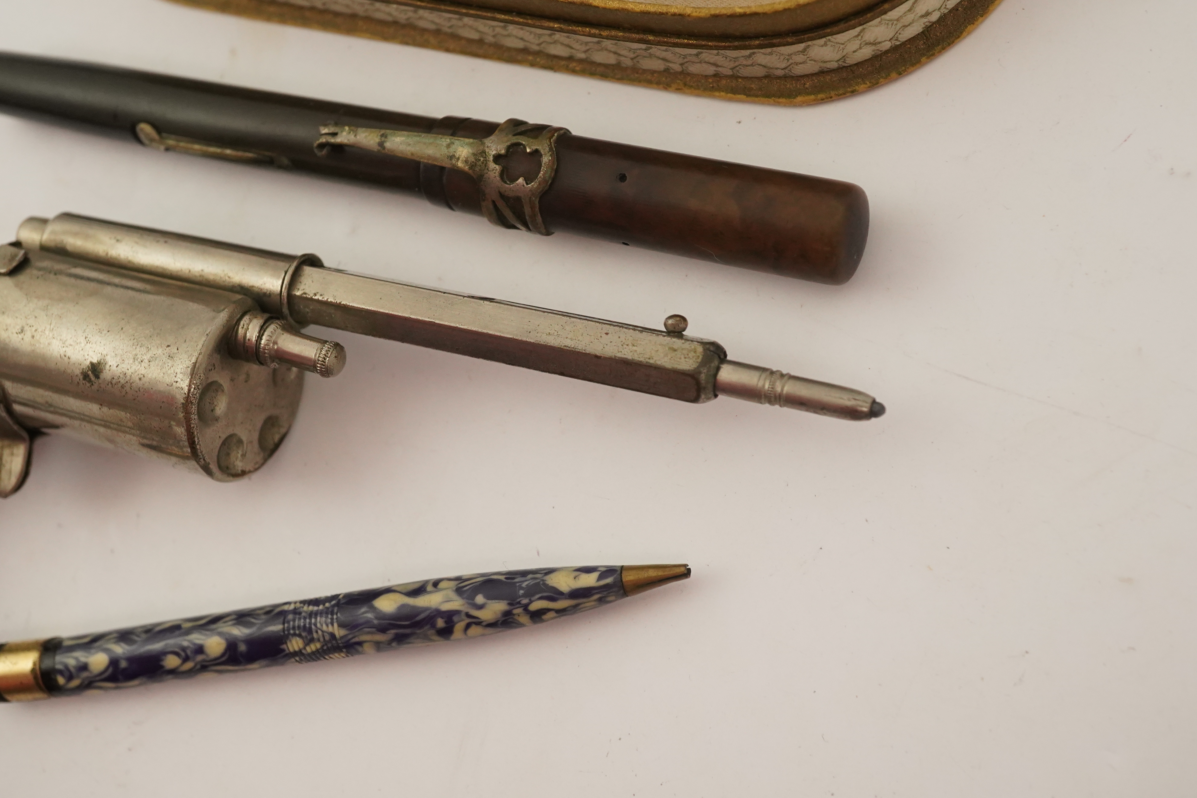 A novelty gun propelling pencil, a gold plated De La Rue Onoto fountain pen and matching pencil, in original box and two other items